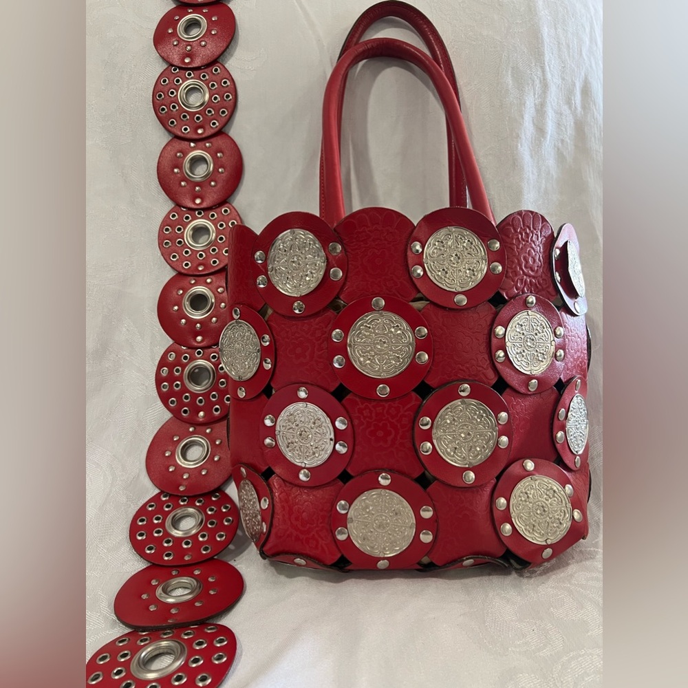 Red leather circle bag with silver accents and coordinating belt